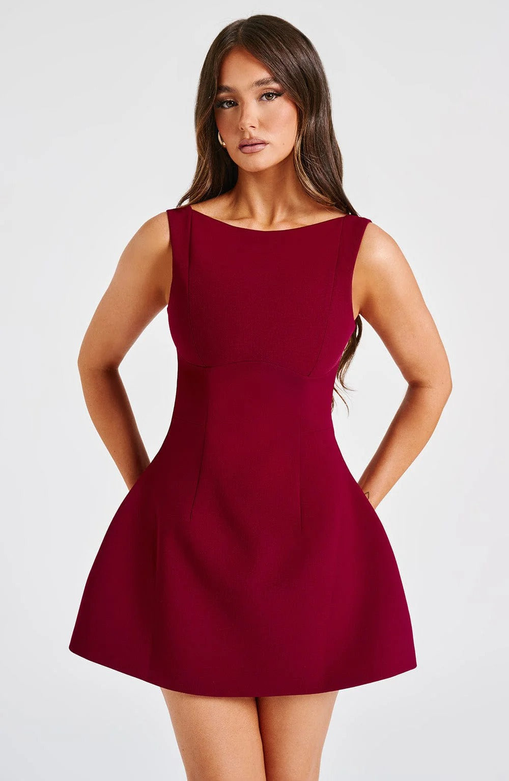 Burgundy sleeveless mini dress with scoop neckline, fitted waist seams and flared skirt front view