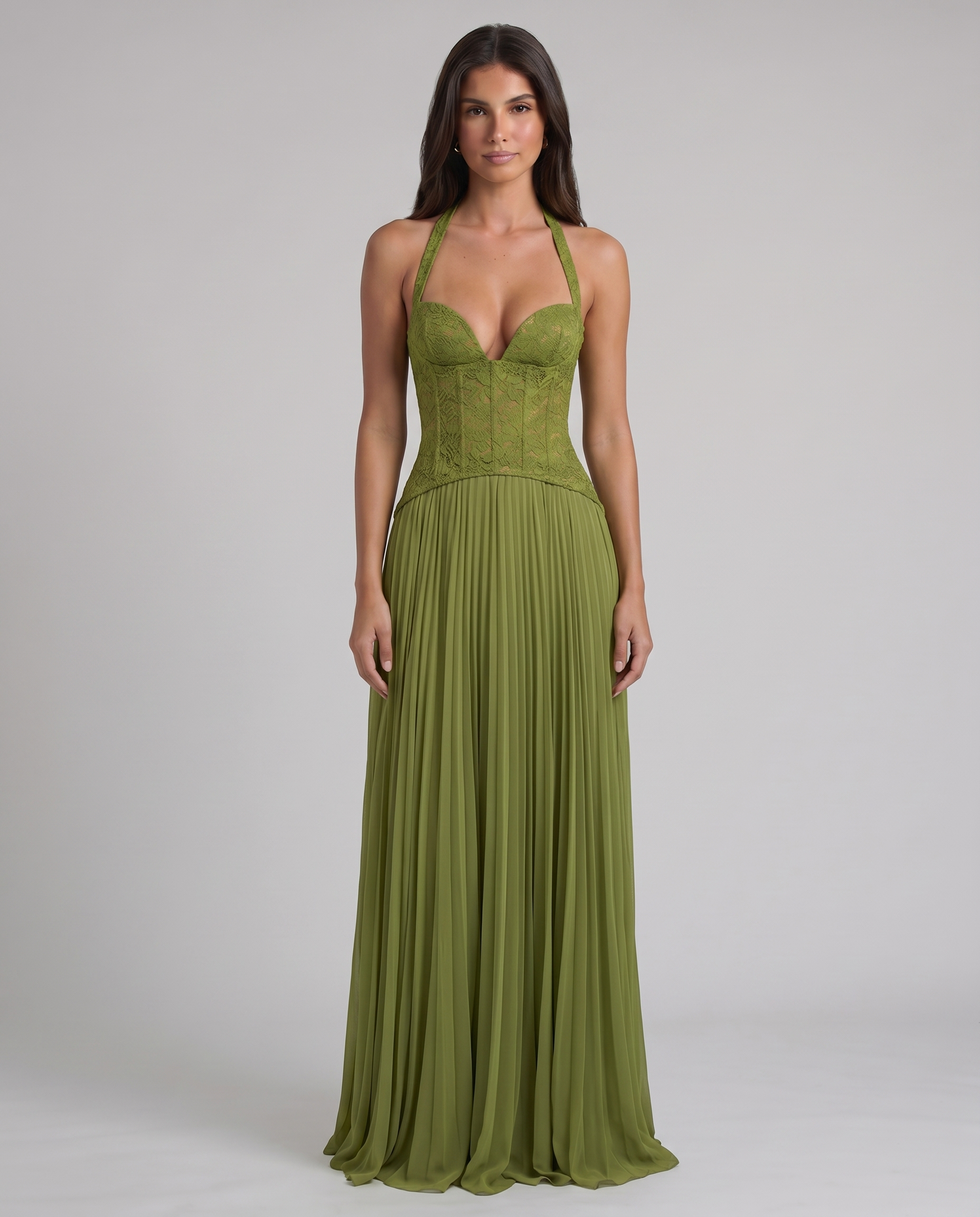 Green halter maxi dress on model, lace bustier top with plunging neckline and flowing pleated hem
