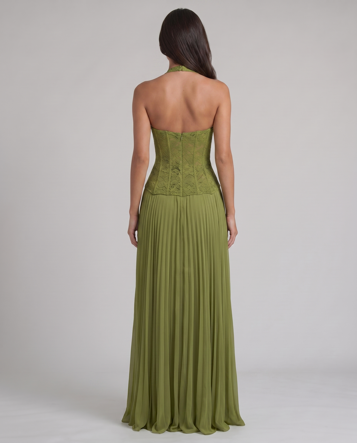 Back view of green maxi dress showing lace corset bodice, halter neck strap, and pleated skirt