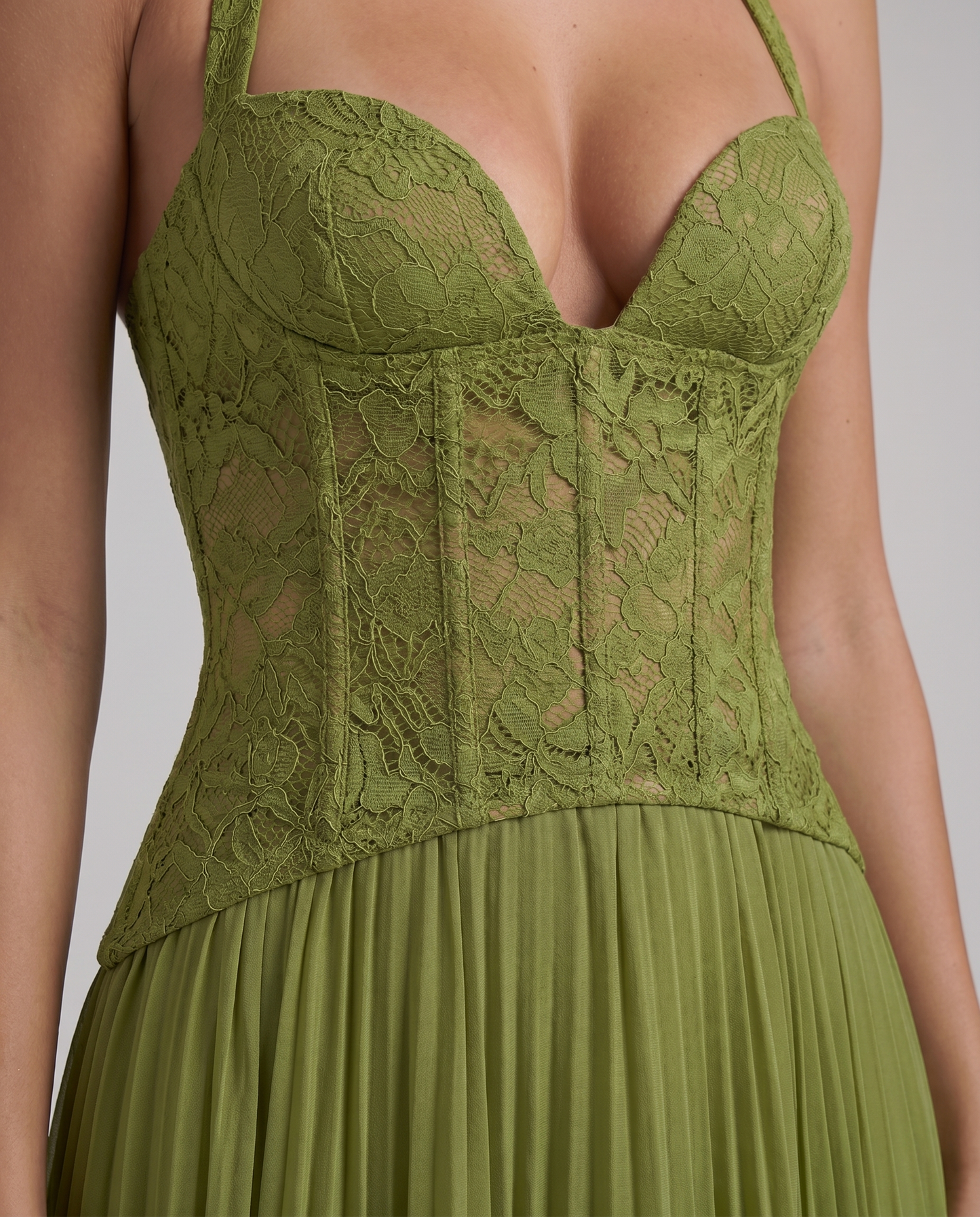 Close-up of green maxi dress lace corset bodice with molded cups, sheer floral lace, and seam details