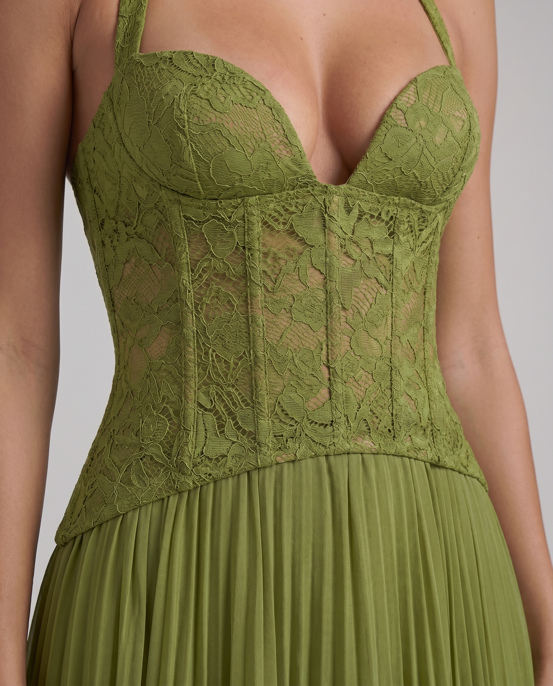 Close-up of green maxi dress lace corset bodice with molded cups, sheer floral lace, and seam details