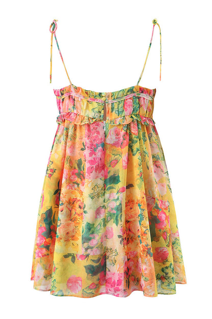 Back flat lay of yellow floral mini dress with adjustable tie straps, elastic top band, and airy skirt