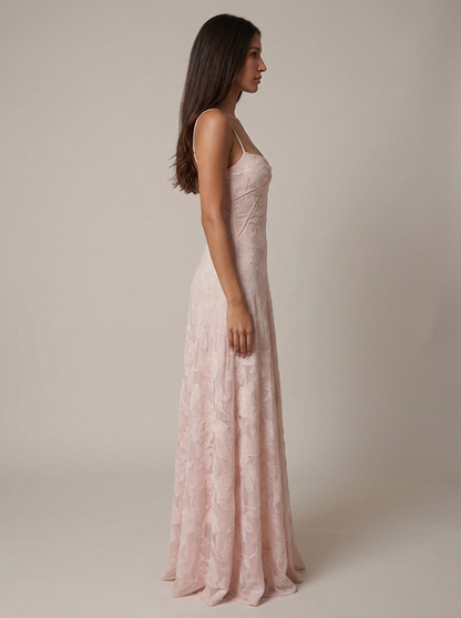 Side view of blush pink flower maxi dress with slim straps, fitted waist and flowing hem