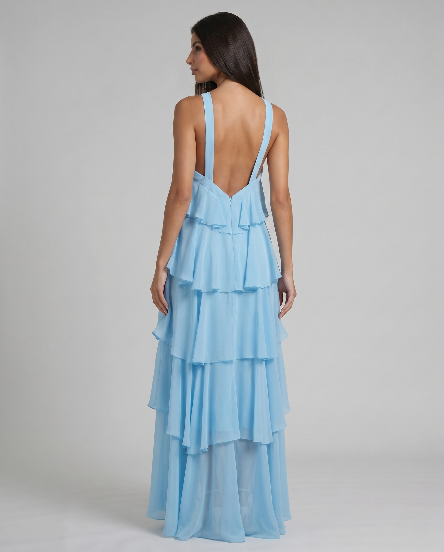 Back view of light blue ruffle maxi dress with low V back and wide straps, layered skirt