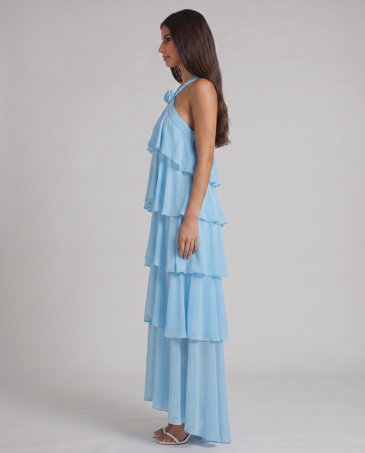 Side view of blue ruffle maxi dress showing cascading tiers and halter strap neckline flower