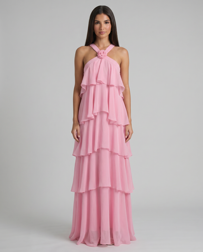 Front view of pink flower ruffle maxi dress featuring cascading ruffle bodice, rosette halter, and tiered hem