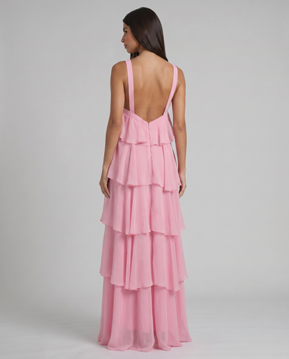 Back view of pink ruffle maxi dress showing low V-back straps, center zipper, and tiered skirt