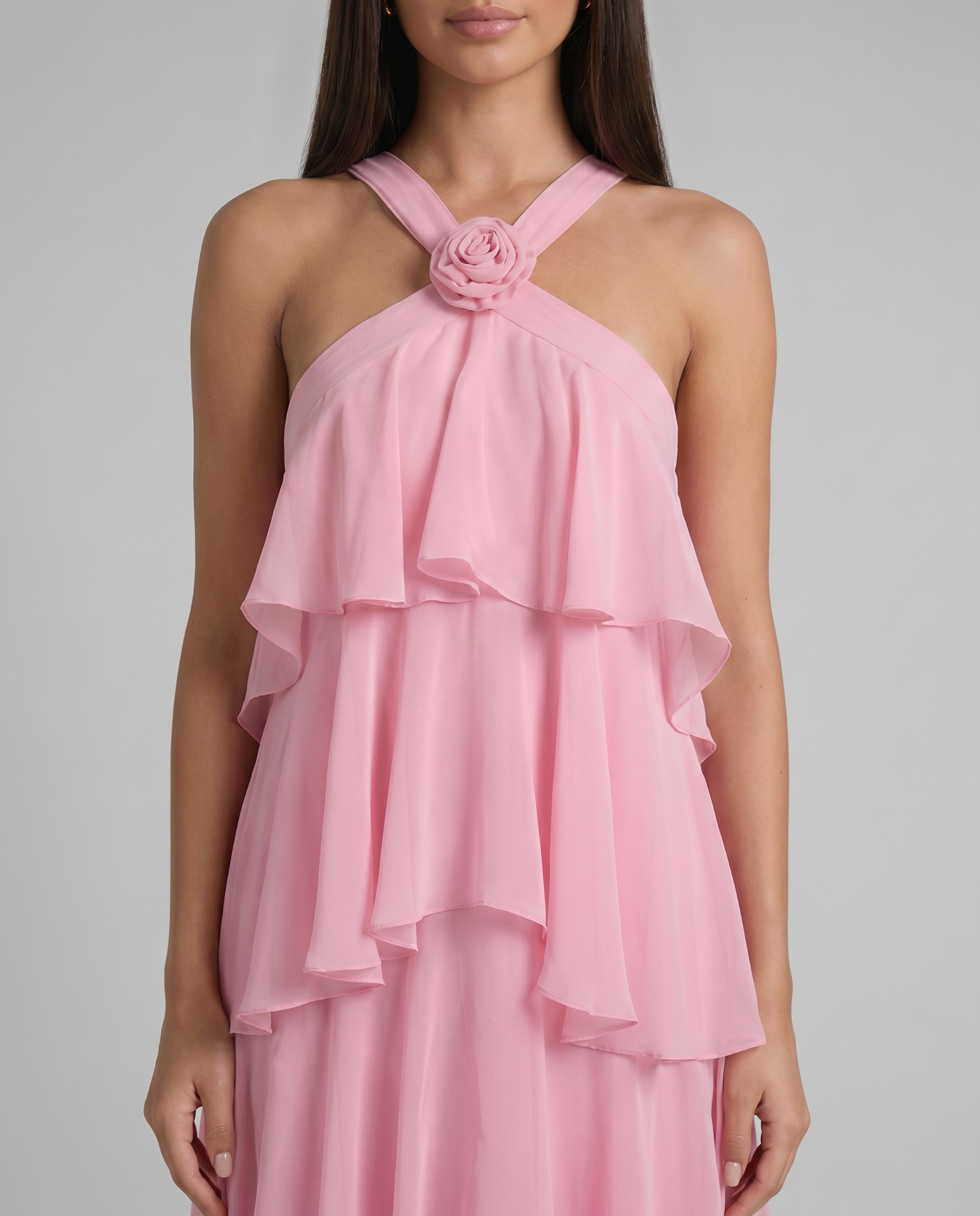 Close-up of pink flower ruffle maxi dress bodice with rosette centerpiece and soft layered chiffon ruffles