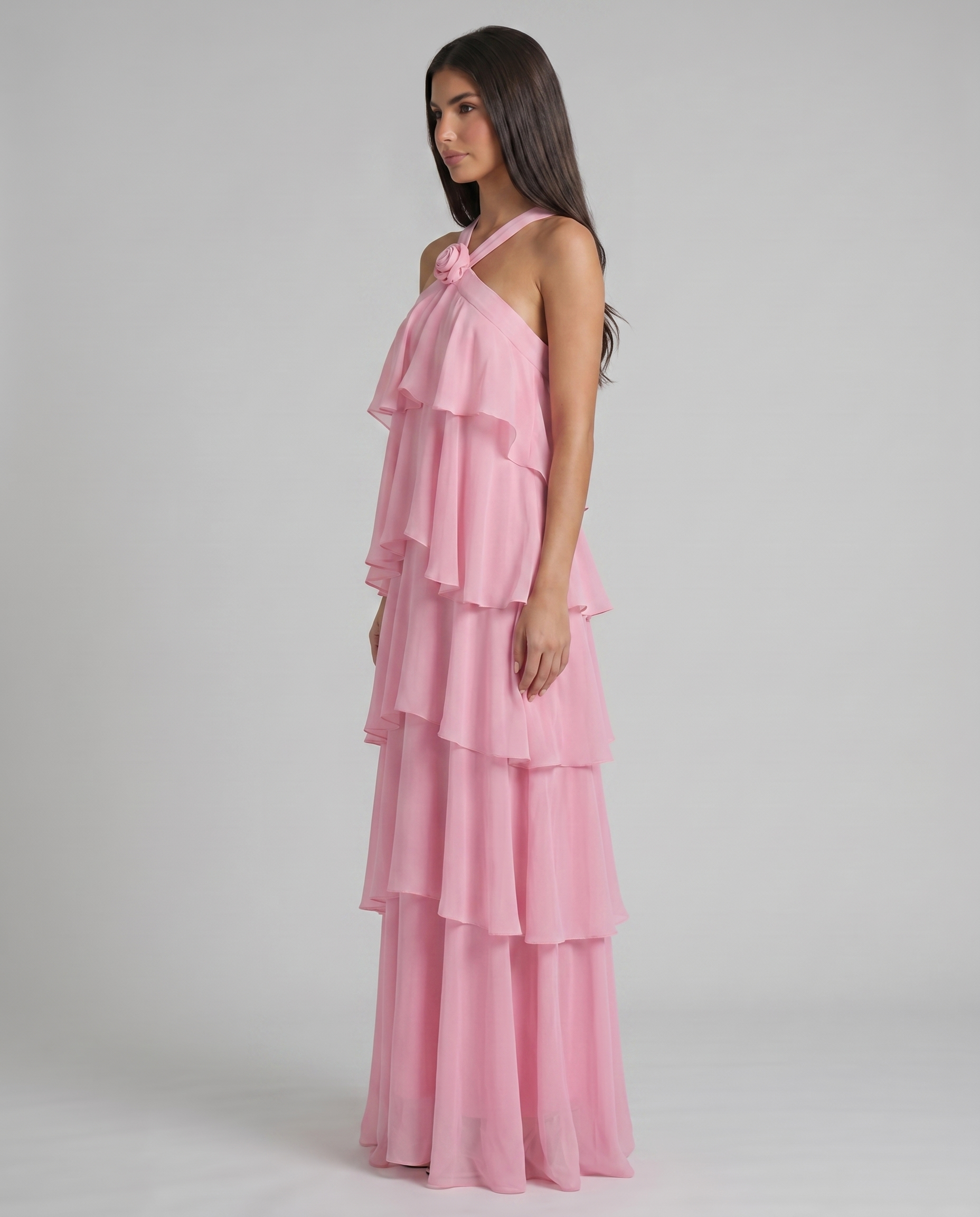 Profile shot of pink flower ruffle maxi dress highlighting layered chiffon tiers and relaxed, flowing silhouette
