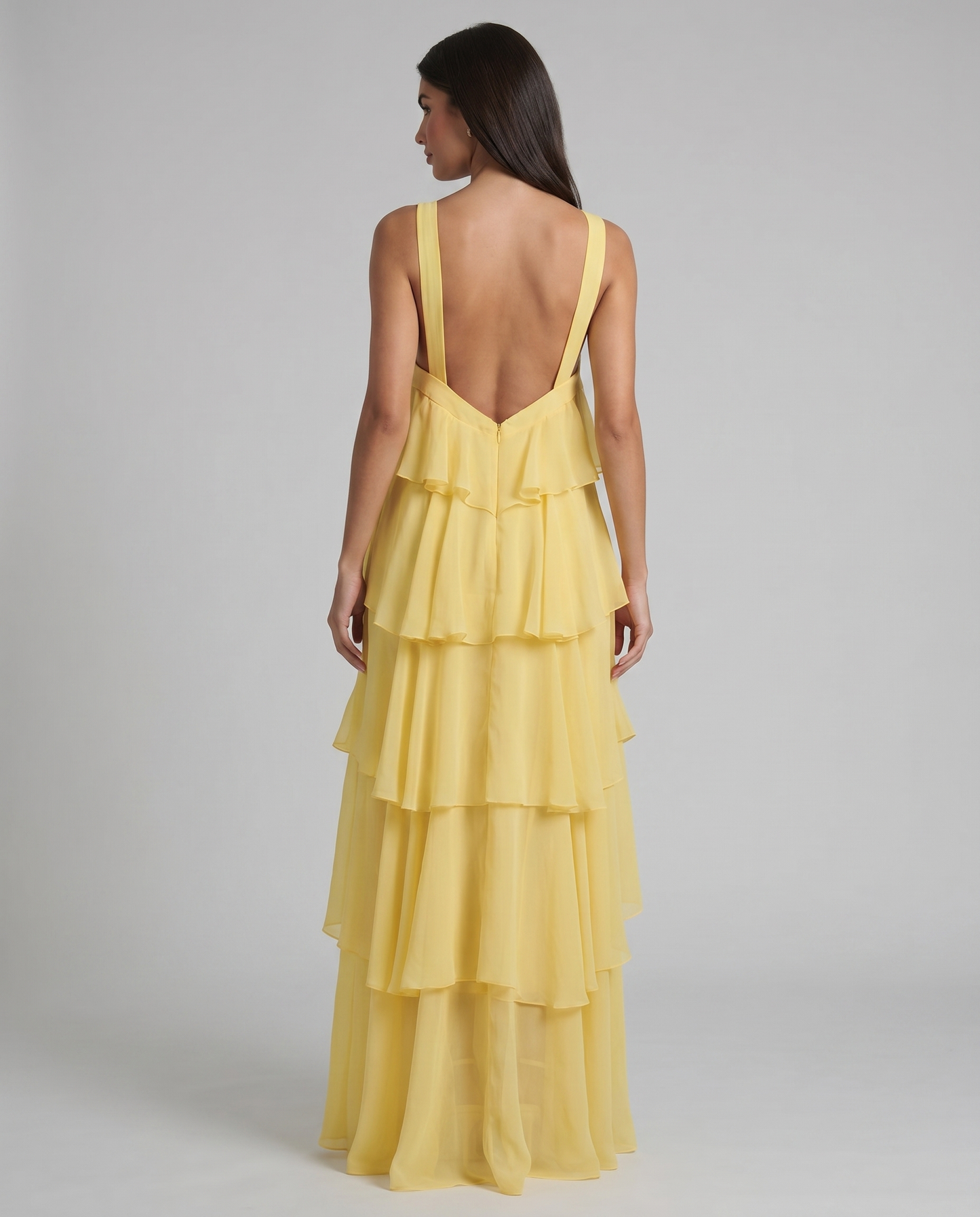 Back angled view of yellow tiered ruffle maxi dress with wide straps and flowy chiffon layers