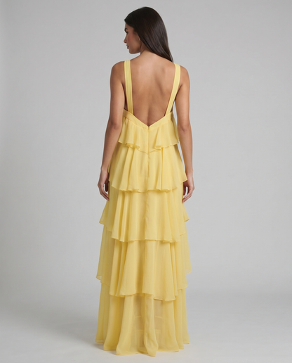 Back angled view of yellow tiered ruffle maxi dress with wide straps and flowy chiffon layers