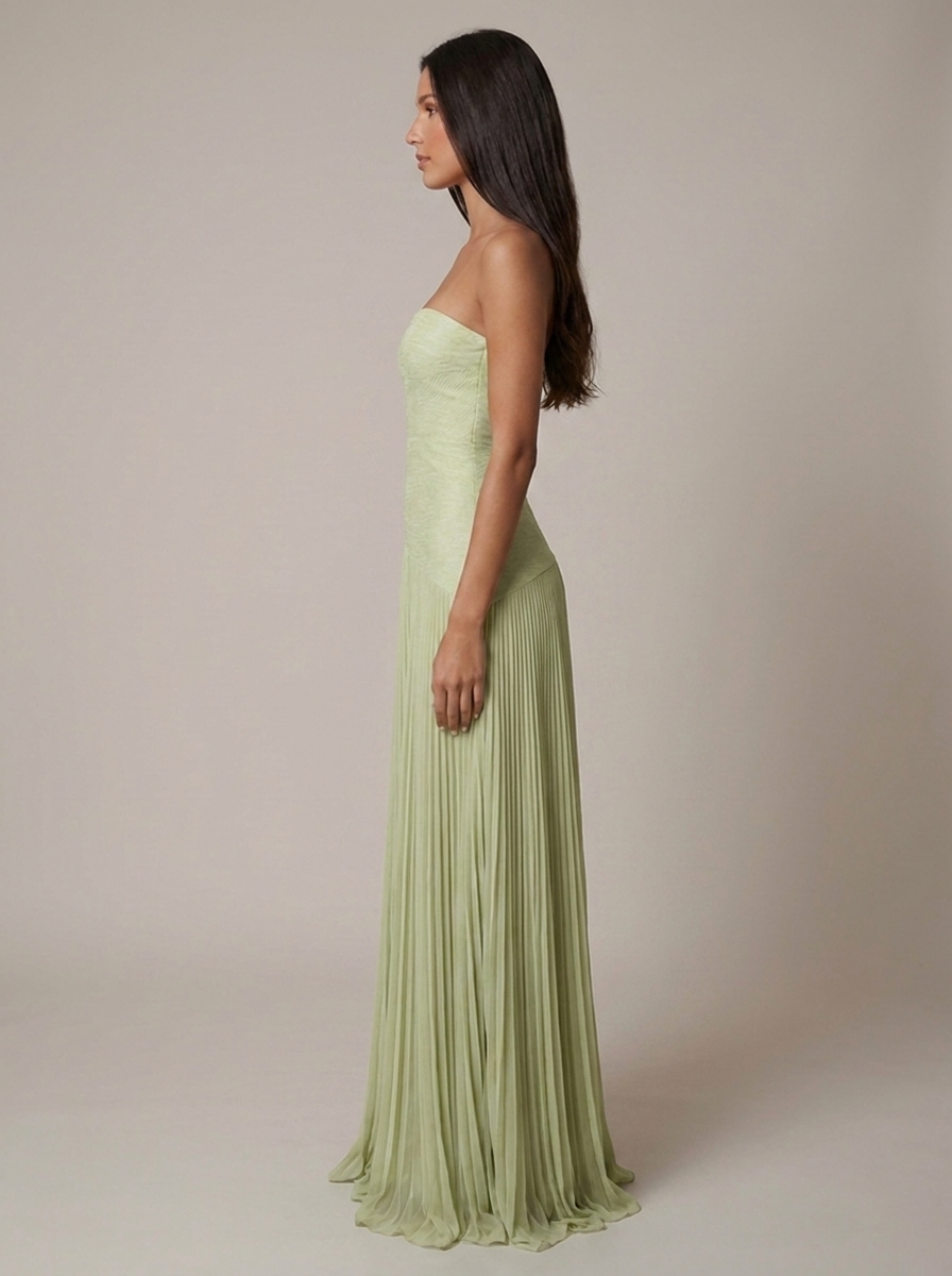 Left side view of light green strapless maxi dress with smooth fitted bodice and pleated skirt