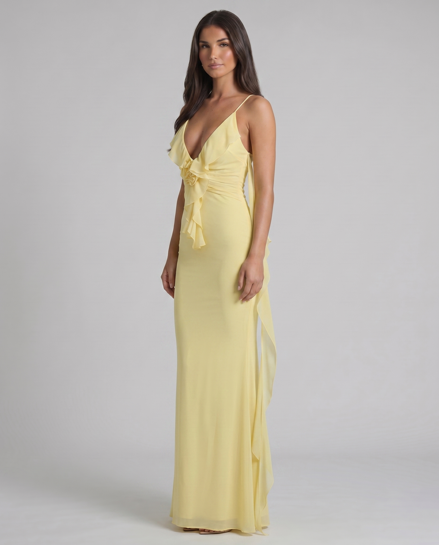 Angled view of yellow maxi dress with plunging V-neck, ruched waist and cascading ruffle front