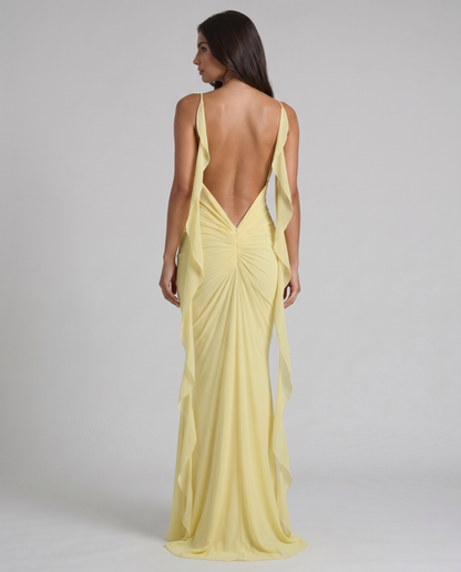 Back view of yellow maxi dress with low V back, ruched center seam and flowing chiffon side drapes