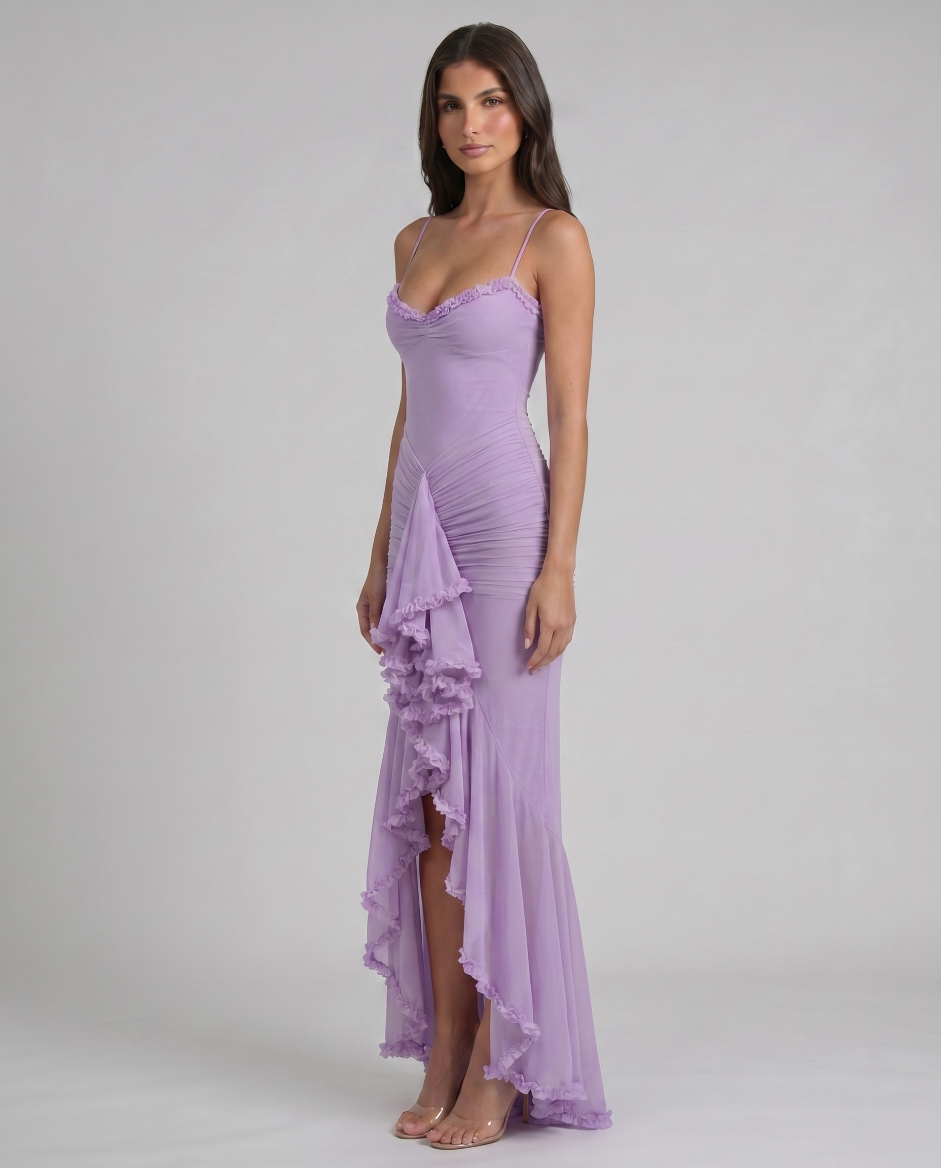 Angled full-length view of purple maxi dress with ruffle cascade, ruched skirt, and front slit opening