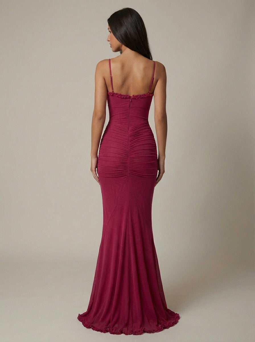 Full-length rear view of deep red maxi dress showing slim straps, ruched back skirt, and ruffle hem edge