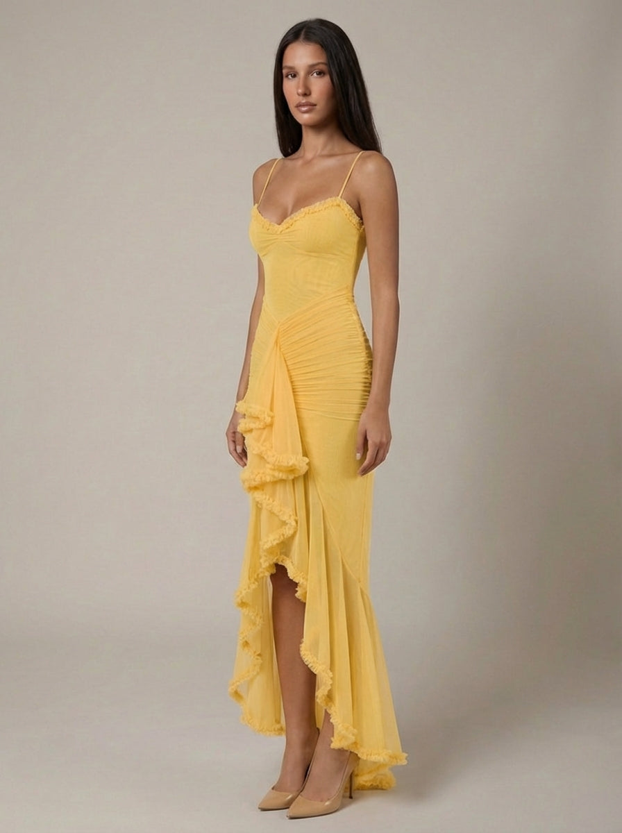 Full-length yellow maxi dress with fitted bodice, gathered waist drape and cascading ruffle detail