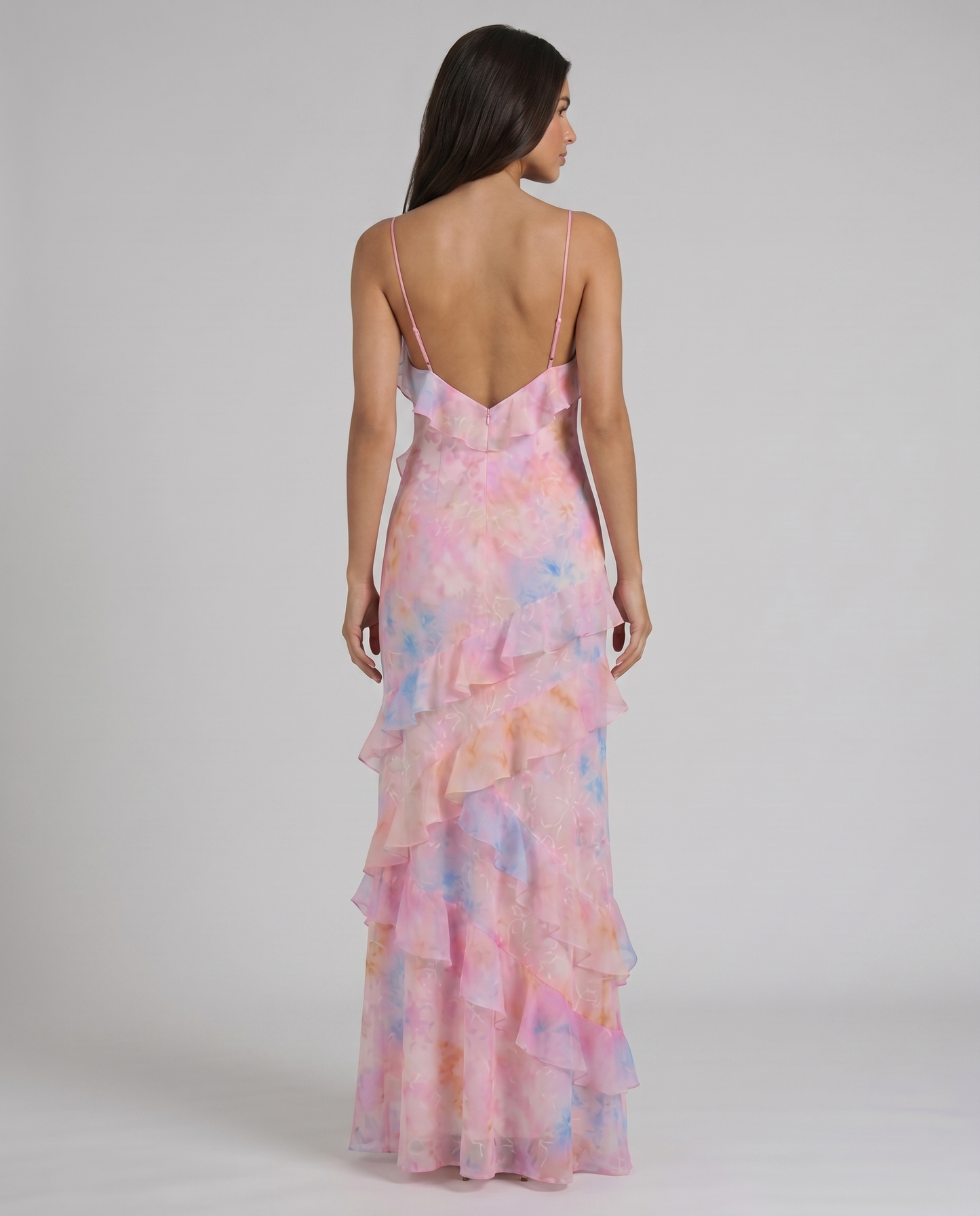 Back view of pink tie-dye maxi dress with low v-back, thin straps, and center back zipper