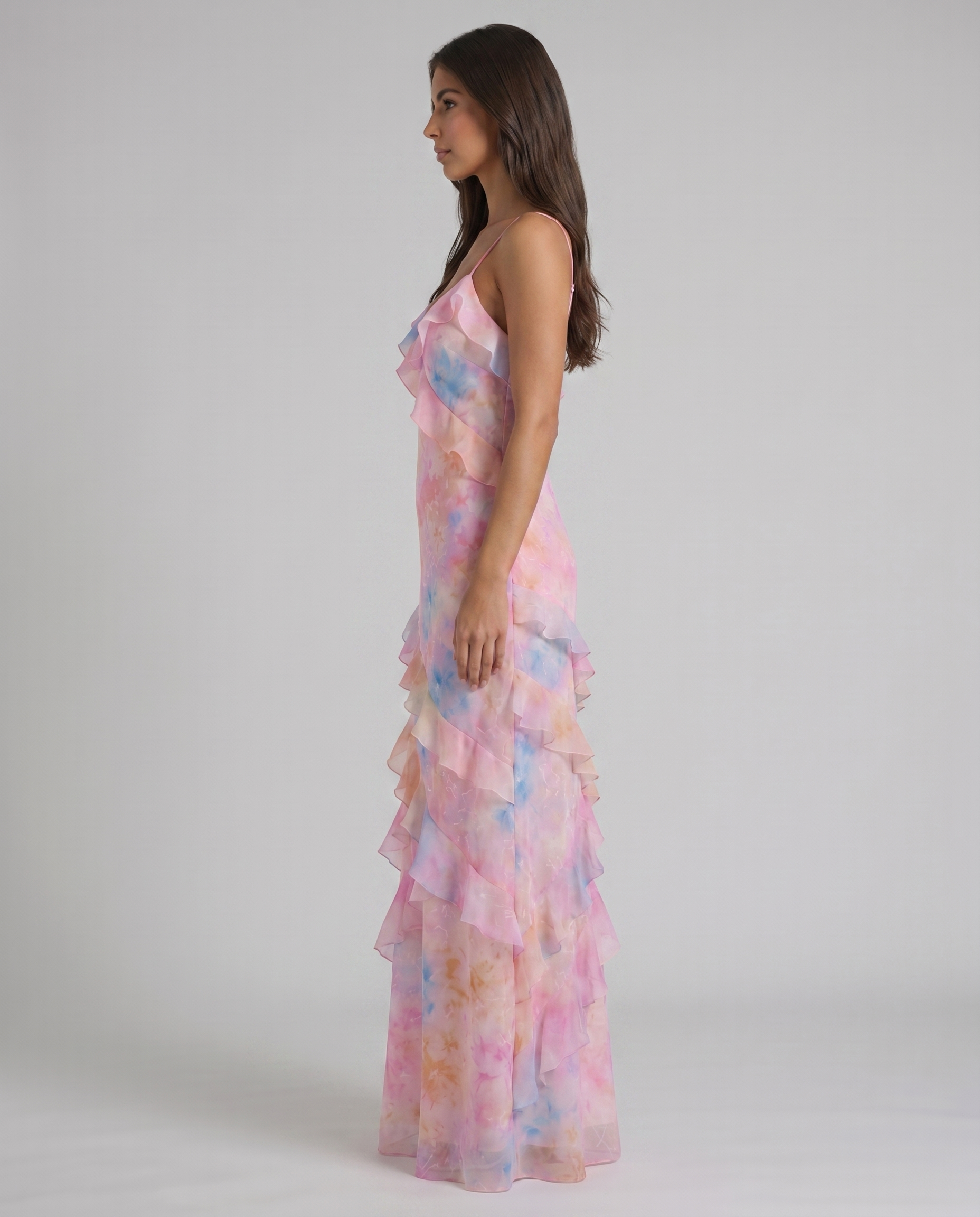 Side profile of pink tie-dye ruffle maxi dress showing slim fit bodice and tiered hem