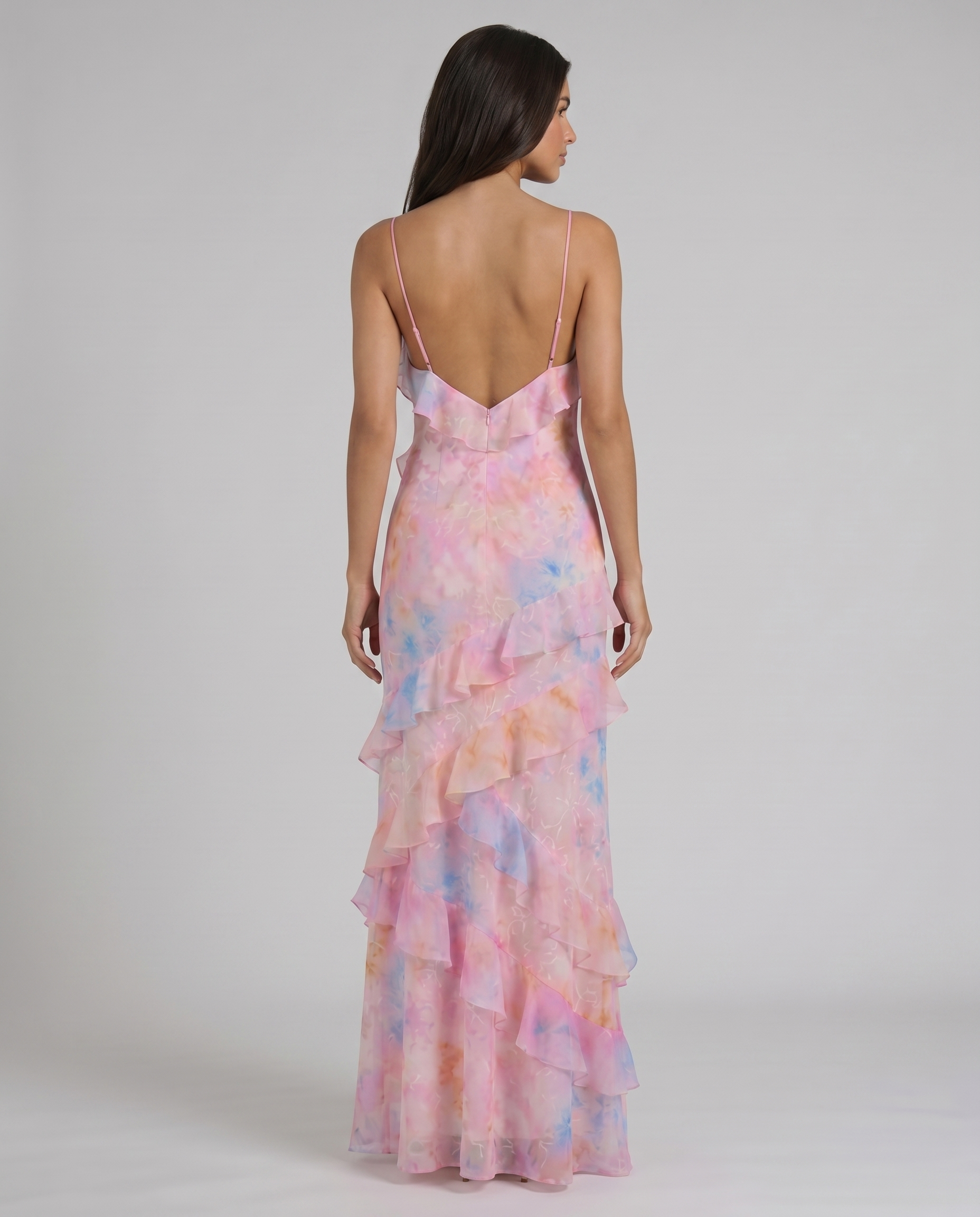 Rear full-length view of pink tie-dye maxi dress highlighting low back and cascading ruffle tiers