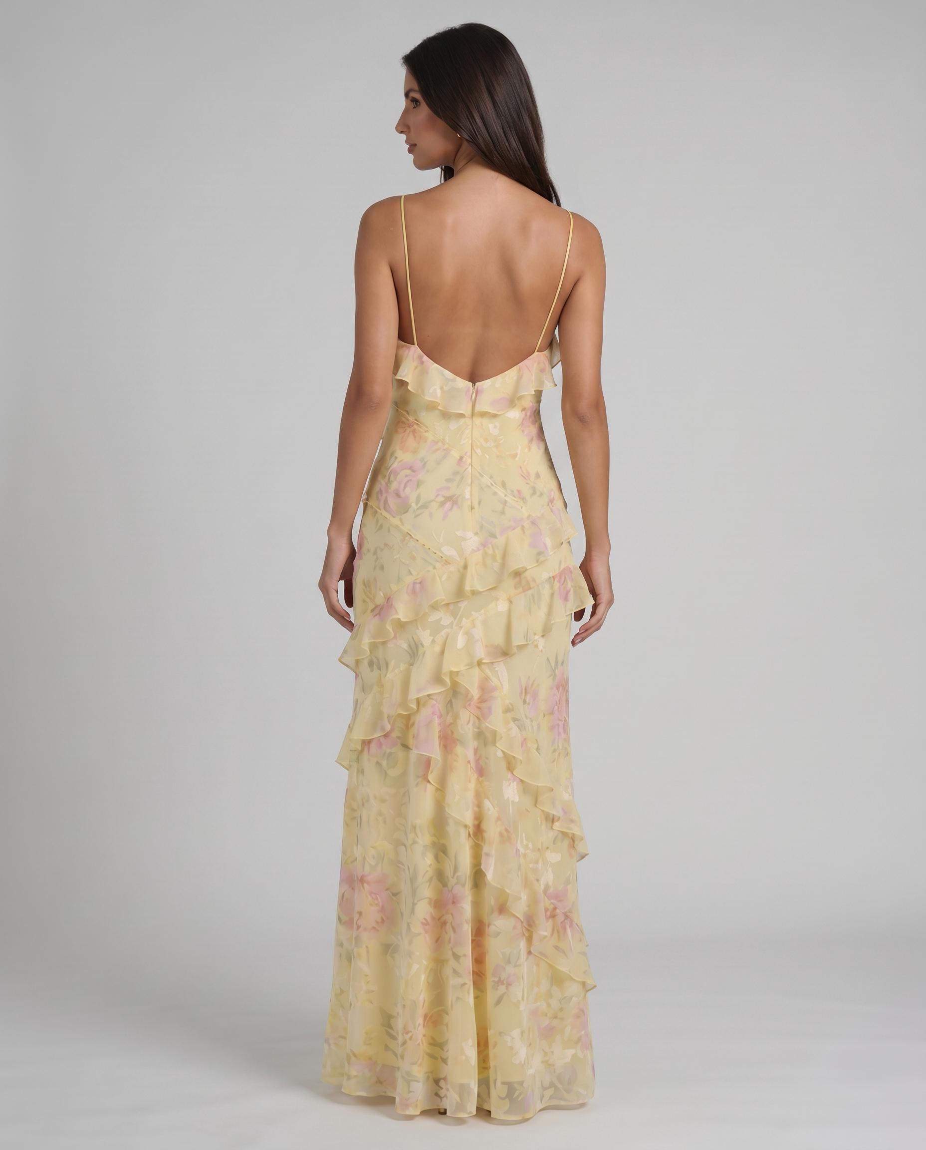 Back view yellow floral maxi dress with low V back, thin straps, and soft ruffle tiers