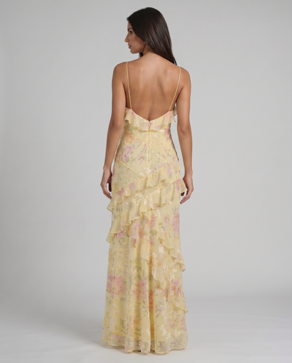Back view yellow floral maxi dress with low V back, thin straps, and soft ruffle tiers