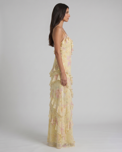 Side profile of yellow floral maxi dress highlighting the slim fit and tiered ruffle skirt