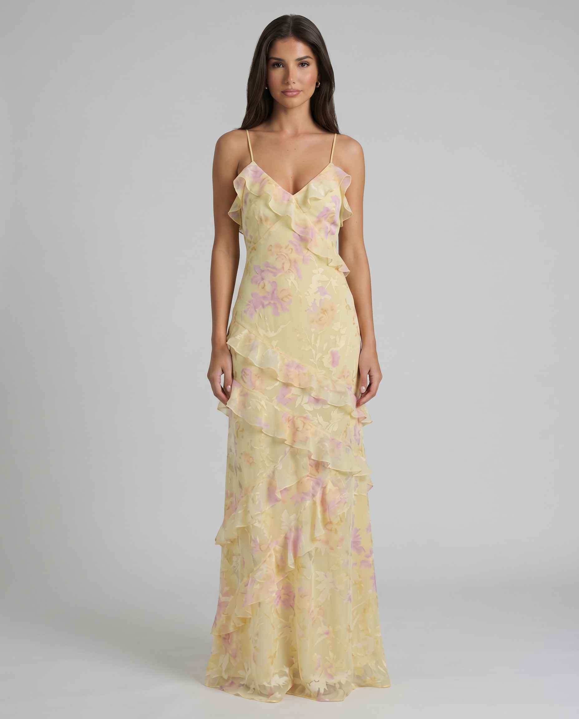 Front view of yellow floral maxi dress with spaghetti straps, ruffle V-neck, and tiered skirt