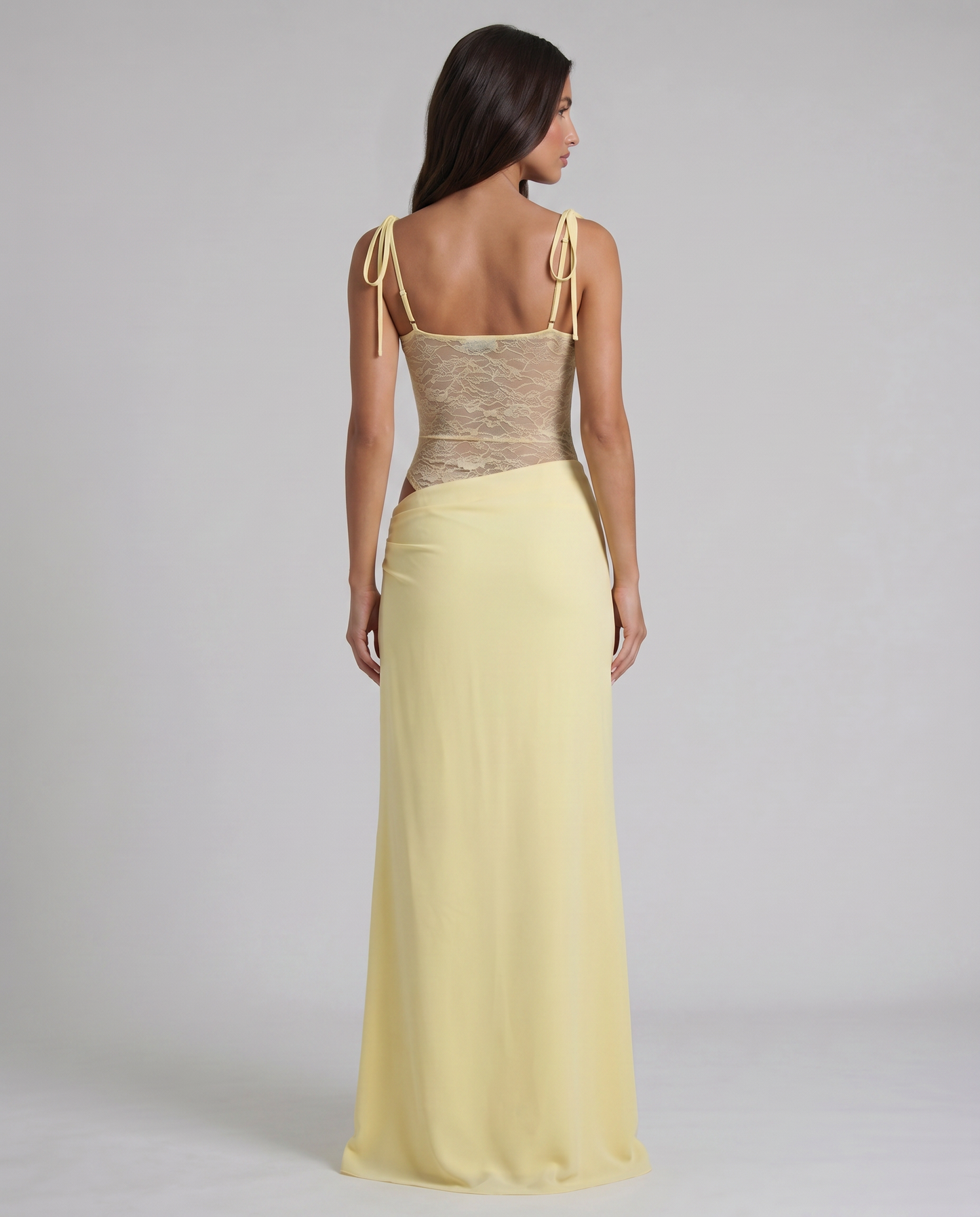 Back close-up of yellow maxi dress highlighting lace bodice texture and slim shoulder tie straps