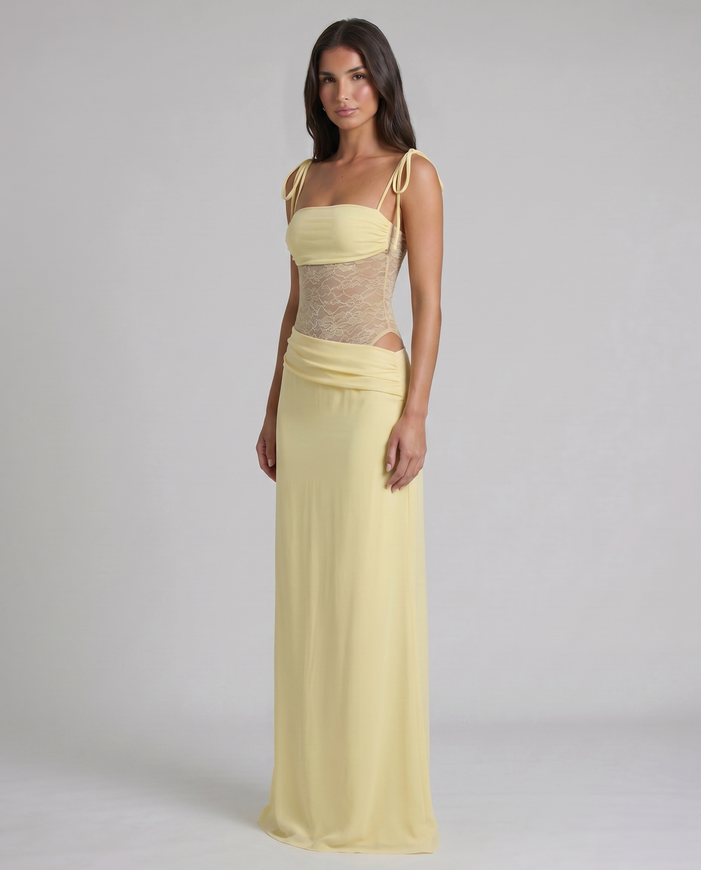 Three-quarter front view yellow maxi dress showing lace bodice, ruched waist drape, and long skirt
