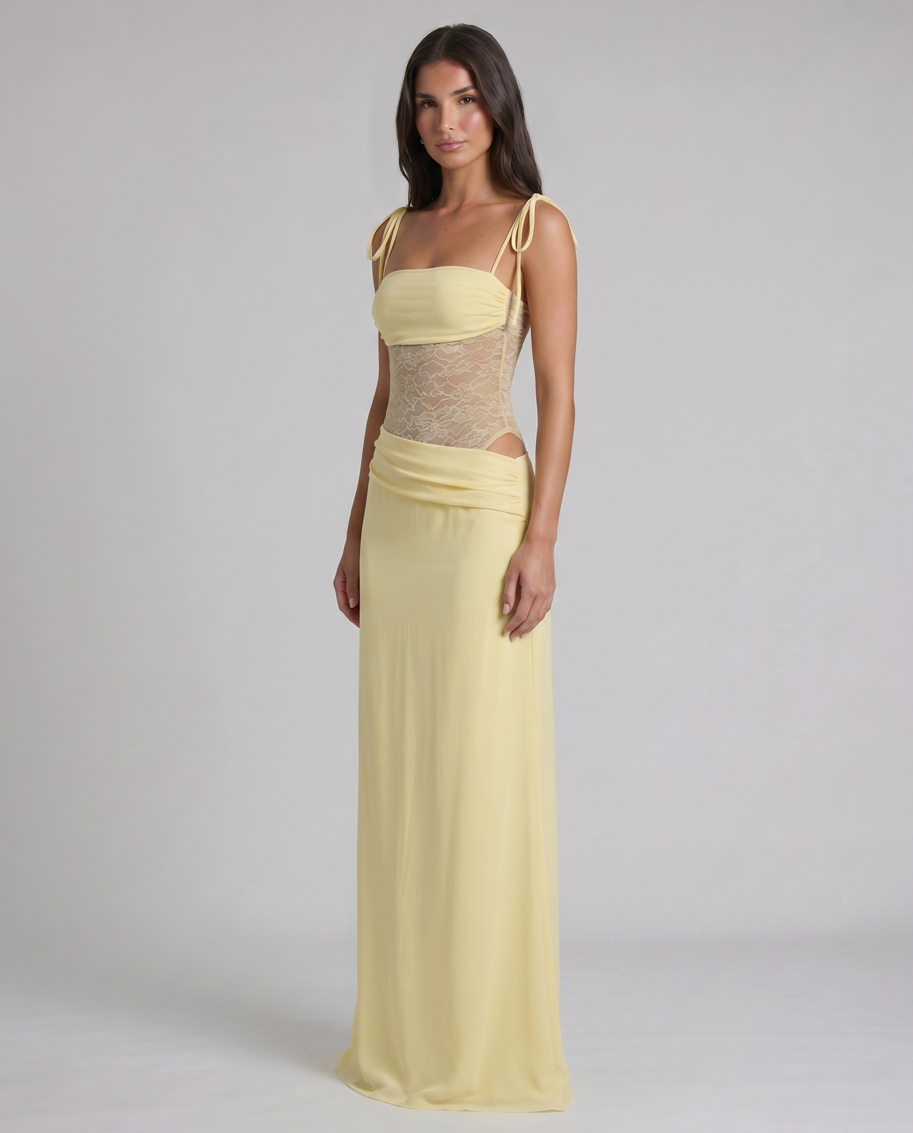 Three-quarter front view yellow maxi dress showing lace bodice, ruched waist drape, and long skirt