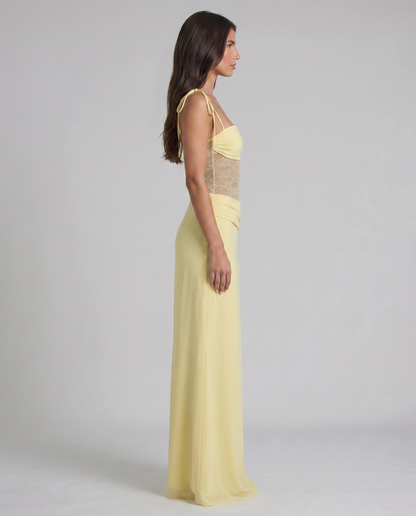 Waist detail of pale yellow maxi dress with layered ruching over the hips and smooth skirt fabric
