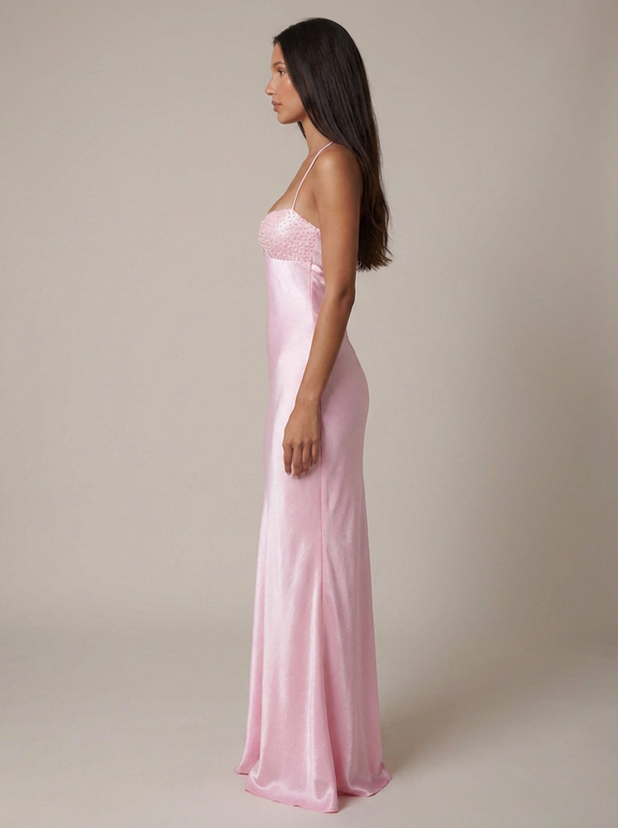 Side profile of pink satin maxi dress with slim fit skirt and beaded sweetheart neckline