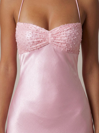 Detailed view of pink satin maxi dress top with textured beaded cups and gathered center