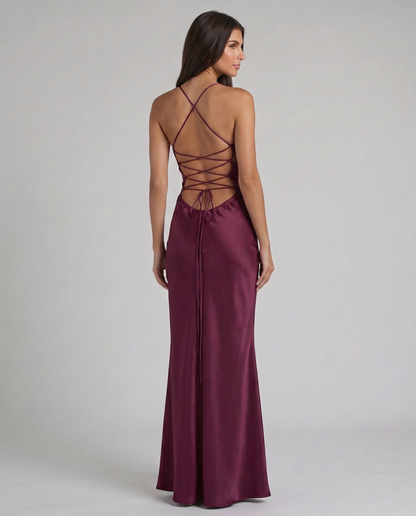 Detail of crisscross lace-up back on purple maxi dress with thin straps and open back design