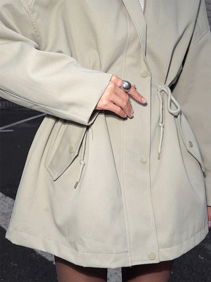 Women tan utility jacket with stand collar, snap front and drawstring gathered waist