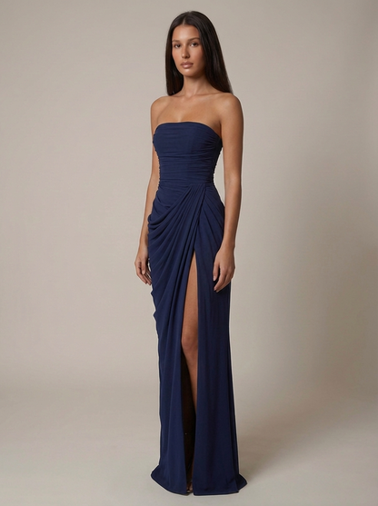 Angled front navy maxi dress with ruched torso, asymmetric draping at hip, and long slit