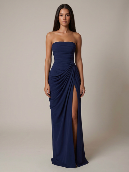 Navy strapless maxi dress with ruched bodice, draped hip detail, and high leg slit