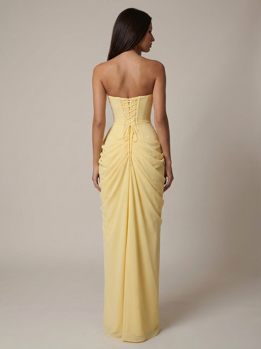 Back view of yellow strapless maxi dress featuring lace-up corset back and gathered skirt