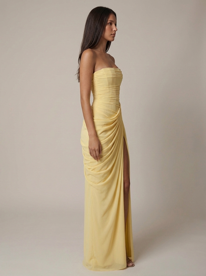 Profile shot of yellow maxi dress highlighting the smooth strapless neckline and flowing hem