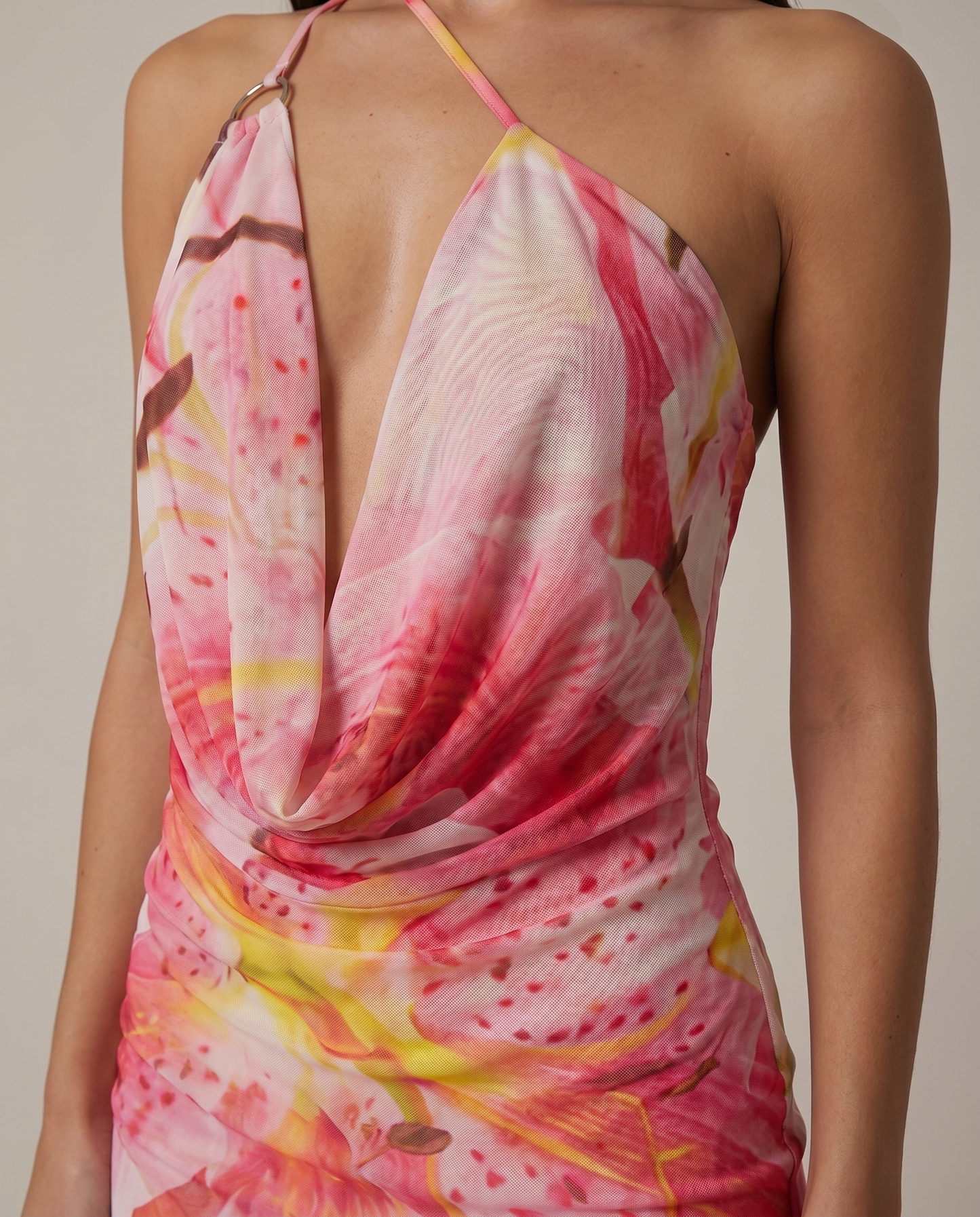 Close-up of white and pink floral mini dress cowl neckline, deep plunge and ring strap detail