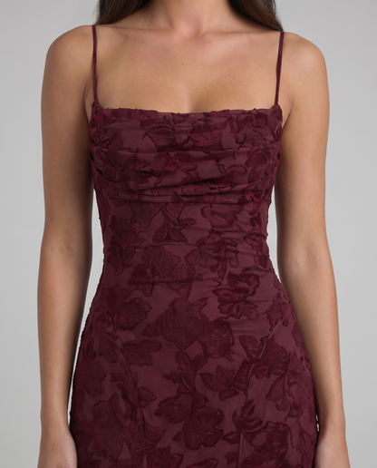 Detailed view of burgundy floral burnout fabric on fitted maxi dress with thin shoulder straps