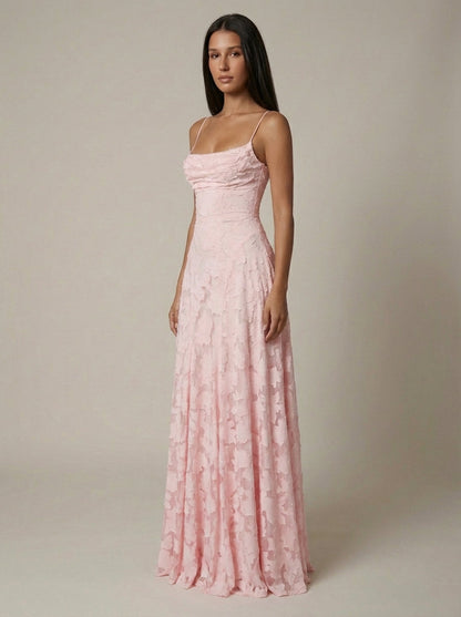 Side angle of blush pink maxi dress with slim straps, fitted waist, and softly draped skirt