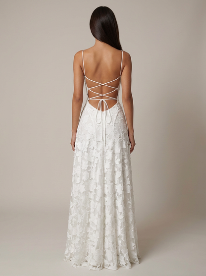 Back view of white lace maxi dress with open back and crisscross lace-up tie straps, floor-length skirt