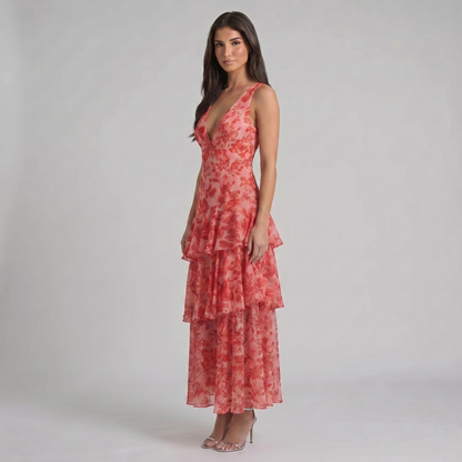 Three-quarter view red floral maxi dress featuring sleeveless plunge neckline and layered skirt