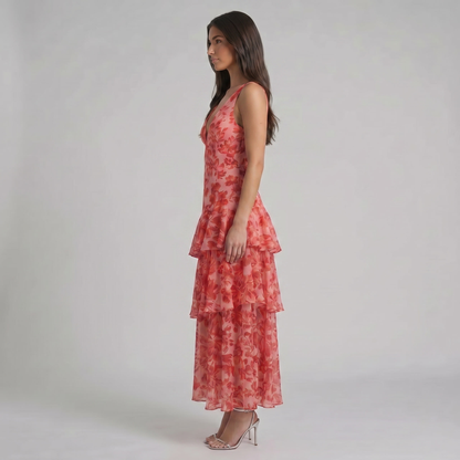 Side profile red floral chiffon maxi dress with fitted bodice and cascading tiered ruffles