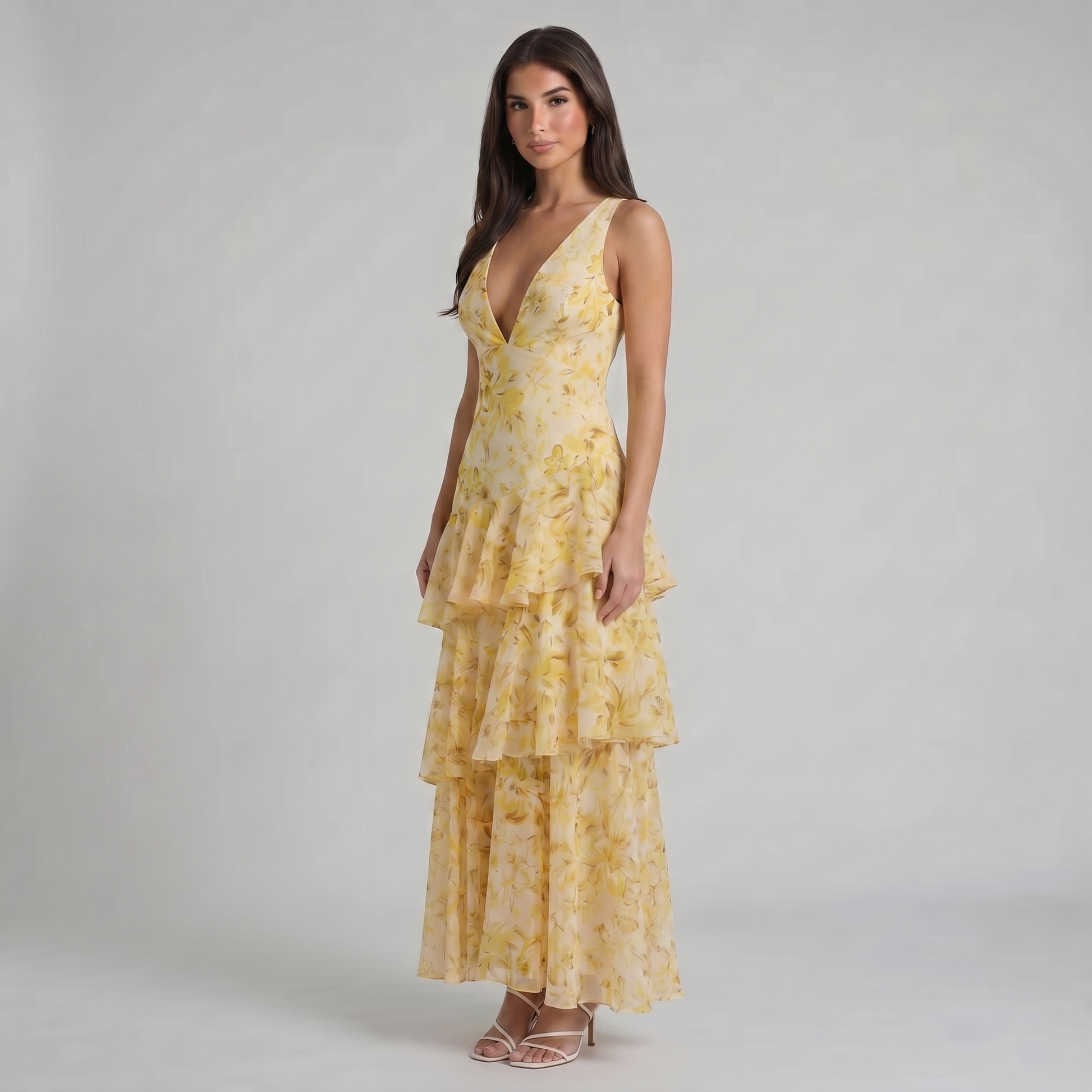 Three-quarter full-length shot of yellow floral maxi dress with flowing tiered skirt and flare