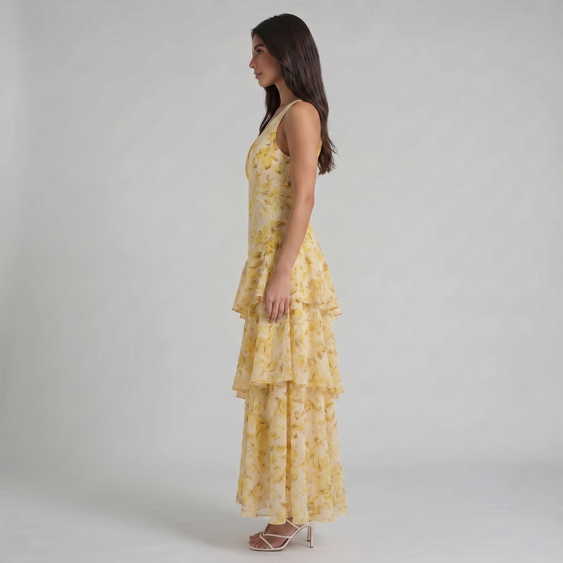 Mid-length side view of yellow floral maxi dress highlighting cascading ruffle tier layers