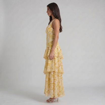 Mid-length side view of yellow floral maxi dress highlighting cascading ruffle tier layers