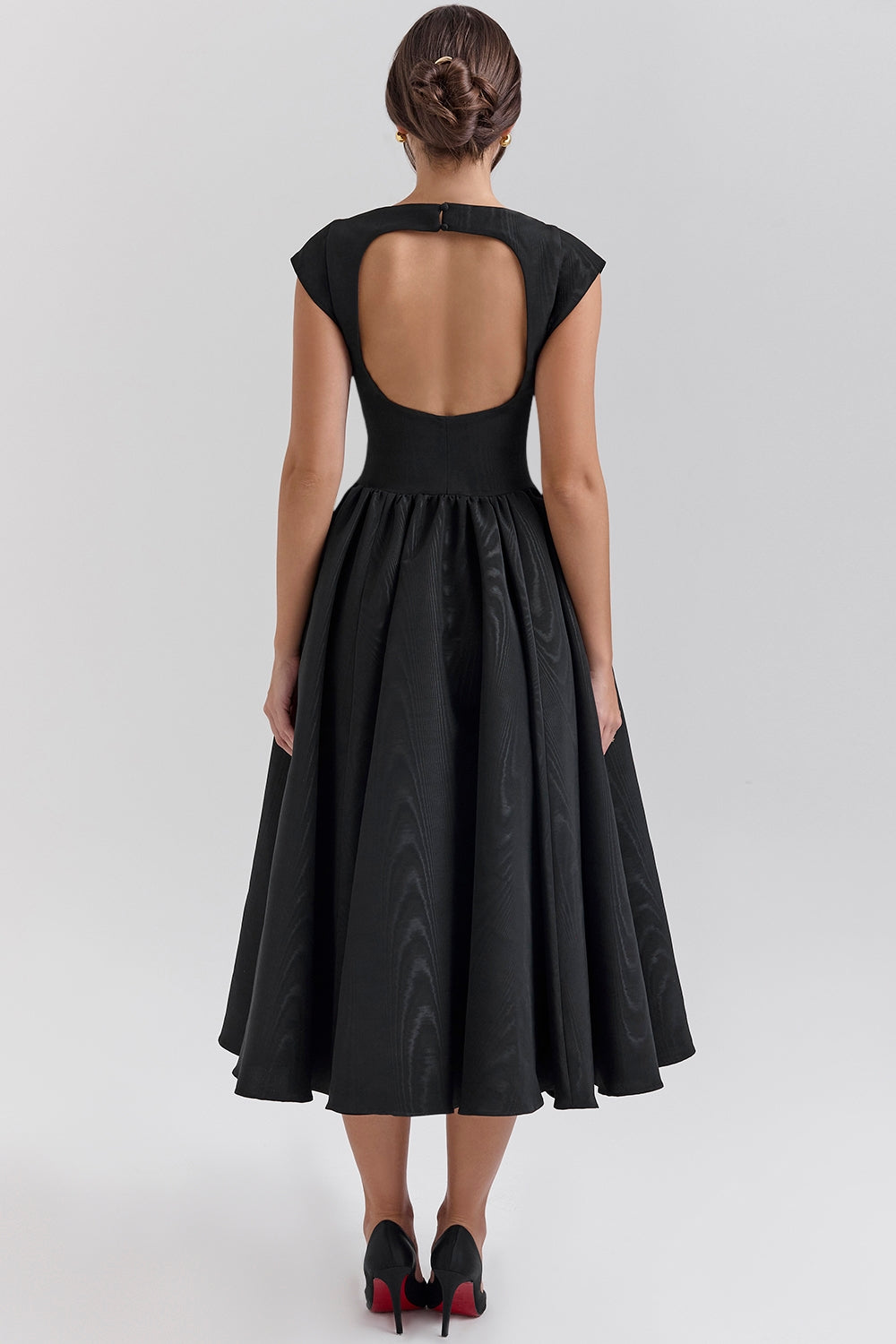 Back view of black midi dress with large scoop back and gathered waist skirt, calf length